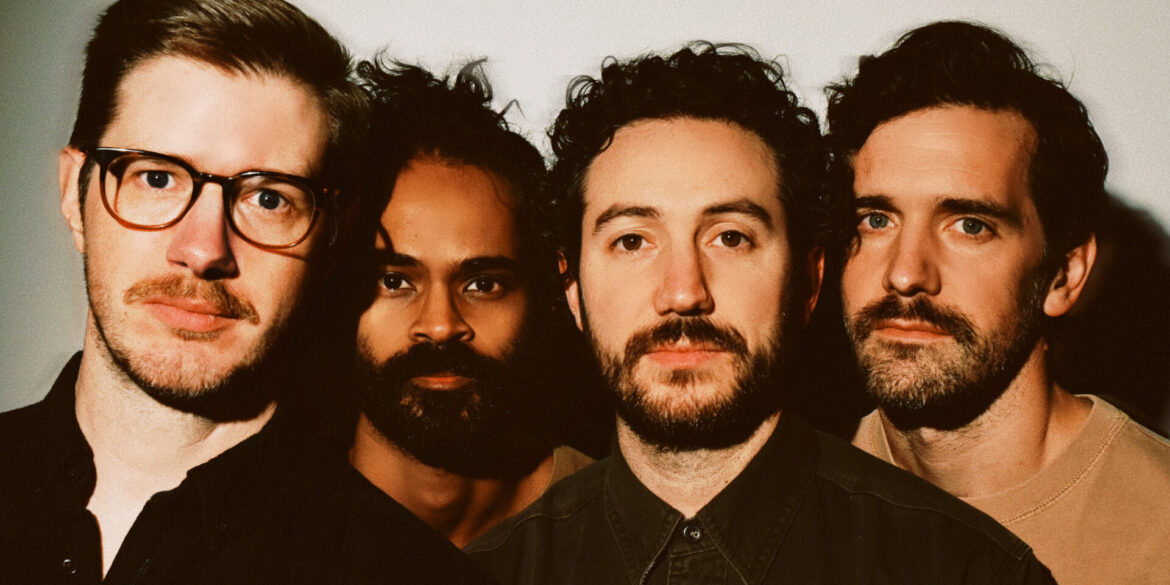 The four members of Darlingside close up looking into the camera.