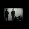 Black and white photo of four members of Folly Group