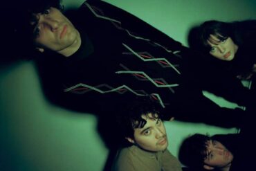 The four members of the band slate