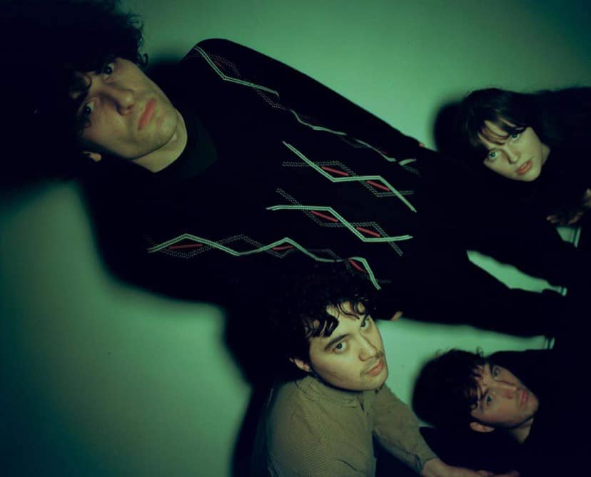 The four members of the band slate