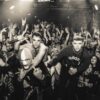 The three band members of Kneecap at a gig