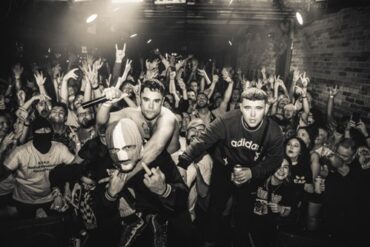 The three band members of Kneecap at a gig