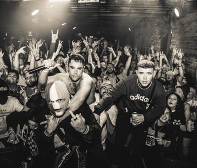 The three band members of Kneecap at a gig