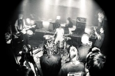 Black and white photo of the band university on stage