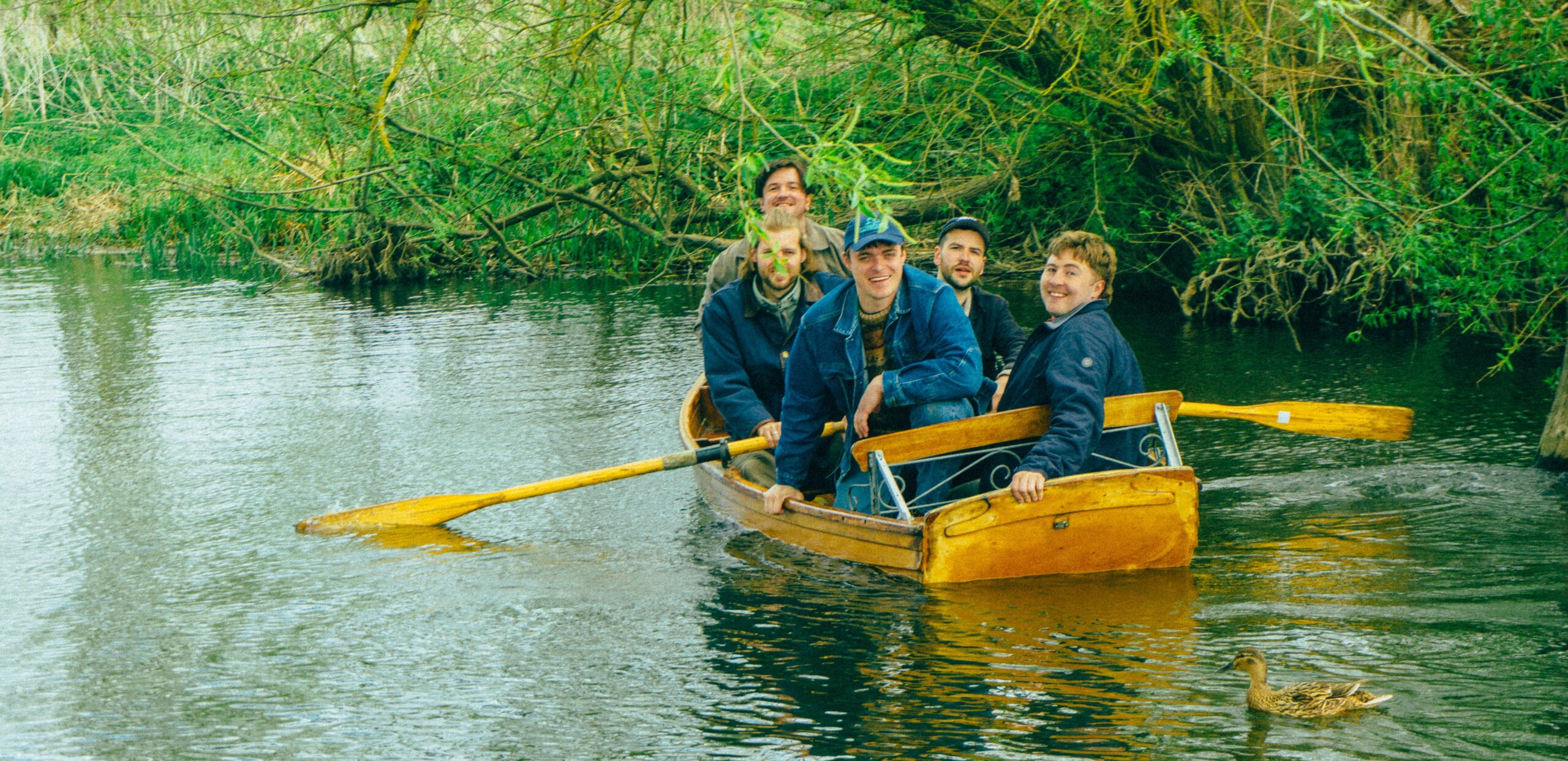 The five members of the band Eades in a canoe