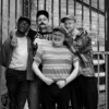 Black and white photo of the four members of the band Thank